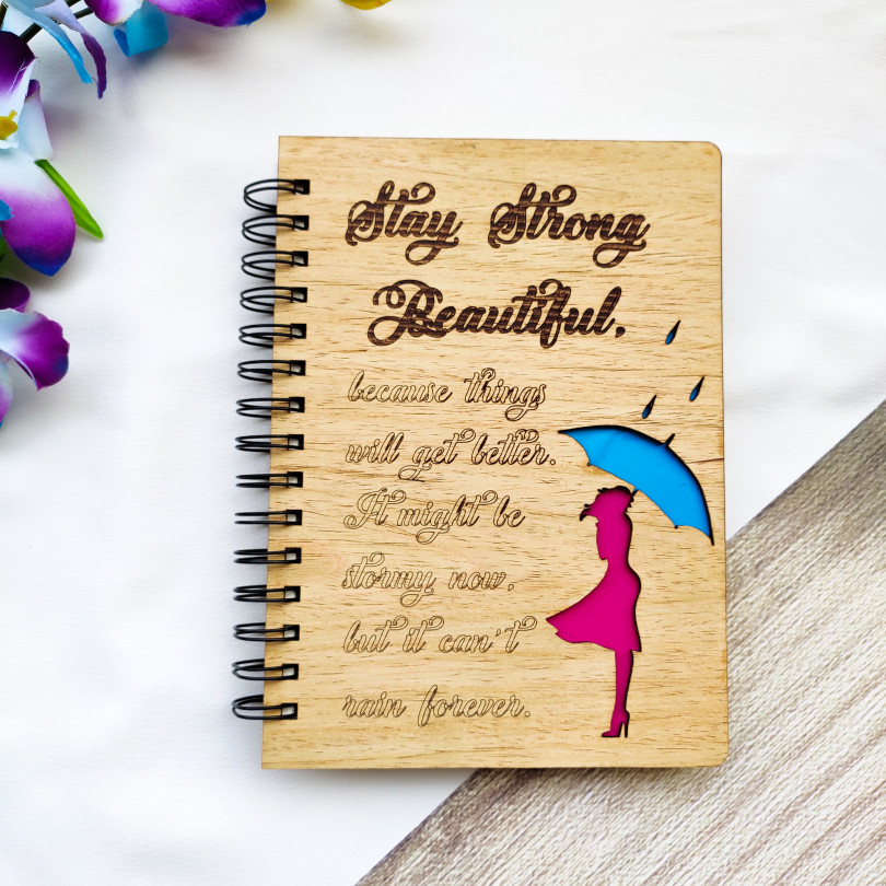 Laser cut and engraved wooden diary with Girl with an umbrella design and a beautiful quote