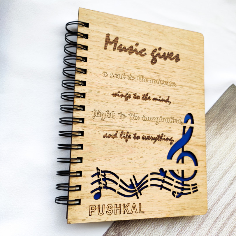Laser cut and engraved wooden diary with musical quote and design
