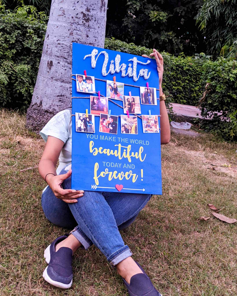 Blue wooden board with photos and string art